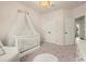 Charming Bedroom featuring a crib with sheer canopy, plush rug, and access to closet at 1590 Branthaven Ln, Auburn, GA 30011