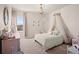 Charming bedroom features a decorative chandelier, bed canopy, and lots of natural light at 1590 Branthaven Ln, Auburn, GA 30011