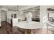 Dining area with marble table and view into the modern kitchen and living space at 1590 Branthaven Ln, Auburn, GA 30011