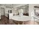 Dining area with marble table and view into the modern kitchen and living space at 1590 Branthaven Ln, Auburn, GA 30011