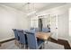 Formal dining room features hardwood floors, French doors, stylish lighting, and seating for six at 1590 Branthaven Ln, Auburn, GA 30011