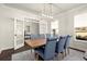 Spacious dining room features hardwood floors, stylish lighting, and French doors to another room at 1590 Branthaven Ln, Auburn, GA 30011