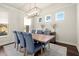 The dining room showcases modern lighting, hardwood floors, and natural light from three picture frame windows at 1590 Branthaven Ln, Auburn, GA 30011