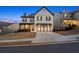 Beautiful two-story home with a black and white facade, manicured lawn, and a welcoming front entrance at 1590 Branthaven Ln, Auburn, GA 30011