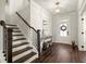 Bright foyer boasts hardwood floors, stairs to the upper level, and front door with sidelights at 1590 Branthaven Ln, Auburn, GA 30011