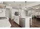 Open concept kitchen with stainless steel appliances and view into the living room at 1590 Branthaven Ln, Auburn, GA 30011