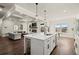 Spacious kitchen with white cabinets and stainless steel appliances, opening to the living room at 1590 Branthaven Ln, Auburn, GA 30011