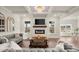 Open living area featuring a brick fireplace, hardwood floors, recessed lighting, and coffered ceilings at 1590 Branthaven Ln, Auburn, GA 30011
