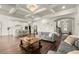 Open concept living room and kitchen featuring hardwood floors, coffered ceilings, and modern stainless appliances at 1590 Branthaven Ln, Auburn, GA 30011