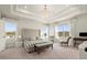 Spacious main bedroom with tray ceiling, chandelier, large windows and upholstered headboard at 1590 Branthaven Ln, Auburn, GA 30011