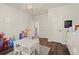 Playroom featuring a white table and chairs, decorative light fixture, wood floors, and white trim and walls at 1590 Branthaven Ln, Auburn, GA 30011