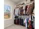 Walk-in closet with an abundance of shelving and hanging space and a bright window at 1590 Branthaven Ln, Auburn, GA 30011