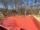 Spacious red deck overlooking a wooded backyard, perfect for outdoor entertaining and relaxation at 25 Cloud Forest Ct, Stockbridge, GA 30281