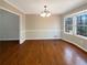 Bright dining room with hardwood floors, neutral paint, and a stylish chandelier at 25 Cloud Forest Ct, Stockbridge, GA 30281