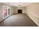 Open living room with a fireplace and French doors leading to the outside at 25 Cloud Forest Ct, Stockbridge, GA 30281