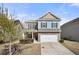 Charming two-story home with a well-manicured front yard and attached two car garage in a quiet neighborhood at 1390 Napa Valley Sw Dr, Lawrenceville, GA 30045