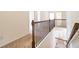 Hallway with carpet floors and wooden railing staircase at 1390 Napa Valley Sw Dr, Lawrenceville, GA 30045