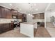 Modern kitchen with granite countertops, stainless steel appliances, dark wood cabinets, and a large island with bar seating at 1390 Napa Valley Sw Dr, Lawrenceville, GA 30045