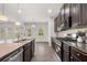 Modern kitchen featuring stainless steel appliances, dark cabinets, granite countertops and a spacious open layout at 1390 Napa Valley Sw Dr, Lawrenceville, GA 30045