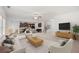 Bright, open-concept living room featuring neutral walls, plush carpet, and seamless flow into the kitchen at 1390 Napa Valley Sw Dr, Lawrenceville, GA 30045