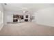 Bright, open-concept living room seamlessly connects to a modern kitchen with dark cabinets and a spacious island at 1390 Napa Valley Sw Dr, Lawrenceville, GA 30045