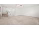 Spacious living room featuring neutral carpet, ample natural light, and open access to the staircase at 1390 Napa Valley Sw Dr, Lawrenceville, GA 30045
