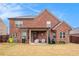 Expansive backyard with lush grass, a covered patio, and beautiful landscaping, ideal for outdoor activities and gatherings at 182 Broder Farms Dr, Stockbridge, GA 30281