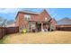 Spacious backyard with a covered patio, perfect for outdoor entertaining and relaxation, surrounded by a fence at 182 Broder Farms Dr, Stockbridge, GA 30281