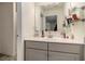 Bathroom featuring a floating glass shelf, mirror, and a gray vanity, offering a modern, minimalist design at 182 Broder Farms Dr, Stockbridge, GA 30281