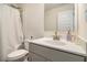 Bathroom featuring a shower with curtain, sink, and a large mirror, all in a bright, neutral color scheme at 182 Broder Farms Dr, Stockbridge, GA 30281