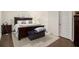 Comfortable bedroom with dark wood furniture and a plush rug at 182 Broder Farms Dr, Stockbridge, GA 30281