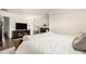 Spacious bedroom with a tv, and a large bed with white comforter at 182 Broder Farms Dr, Stockbridge, GA 30281