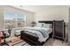 Bedroom with a large window, a queen-sized bed, and carpeted floors, creating a cozy and inviting atmosphere at 182 Broder Farms Dr, Stockbridge, GA 30281