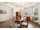 Bright dining room featuring elegant lighting, hardwood floors, and large windows providing ample natural light at 182 Broder Farms Dr, Stockbridge, GA 30281