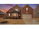Charming brick home with a manicured lawn, complemented by a two car garage and stone architectural features at 182 Broder Farms Dr, Stockbridge, GA 30281