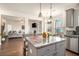 Modern open concept kitchen with stainless appliances, gray cabinets, granite counters and a large island at 182 Broder Farms Dr, Stockbridge, GA 30281