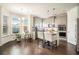 Bright eat in kitchen featuring a center island, stainless appliances, hardwood floors, and ample natural light at 182 Broder Farms Dr, Stockbridge, GA 30281