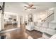 Inviting living room boasting hardwood floors, a staircase and a seamless flow to the modern kitchen at 182 Broder Farms Dr, Stockbridge, GA 30281