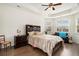 Bright main bedroom features hardwood floors, a ceiling fan, and natural light at 182 Broder Farms Dr, Stockbridge, GA 30281