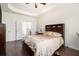 Bright main bedroom features hardwood floors and a ceiling fan at 182 Broder Farms Dr, Stockbridge, GA 30281