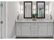 Bathroom with double vanity, sleek white cabinetry, and contemporary lighting at 270 17Th Nw St # 3905, Atlanta, GA 30363