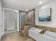 Elegant bathroom featuring a soaking tub, glass shower, and tiled accent wall at 270 17Th Nw St # 3905, Atlanta, GA 30363