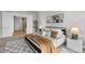 Modern bedroom featuring a comfortable bed, stylish rug, and ensuite bathroom at 270 17Th Nw St # 3905, Atlanta, GA 30363