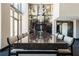Spacious dining room featuring a long granite table, modern chandelier, and floor-to-ceiling windows, perfect for entertaining at 270 17Th Nw St # 3905, Atlanta, GA 30363