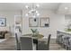 Dining room featuring modern lighting and gray chairs, with a view into living space at 270 17Th Nw St # 3905, Atlanta, GA 30363