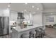 Modern kitchen featuring white cabinets, stainless steel appliances, and a marble waterfall island with seating at 270 17Th Nw St # 3905, Atlanta, GA 30363