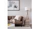Cozy living room featuring a comfortable leather couch, stylish lamp and contemporary art at 270 17Th Nw St # 3905, Atlanta, GA 30363