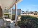 View from porch with white columns and bench with outdoor furniture at 3226 Puritan Way, Mcdonough, GA 30252