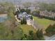 Sprawling estate with manicured grounds, a tennis court, and mature trees from an aerial perspective at , Roswell, GA 30075