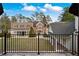 Expansive backyard with lush lawn, mature trees, and an iron fence, providing a private outdoor oasis at , Roswell, GA 30075